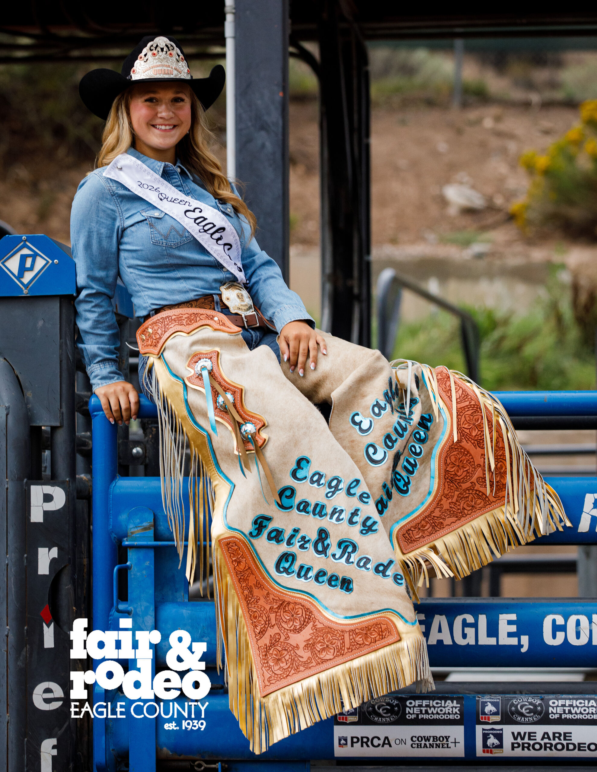 Rodeo Queen sitting on a fence